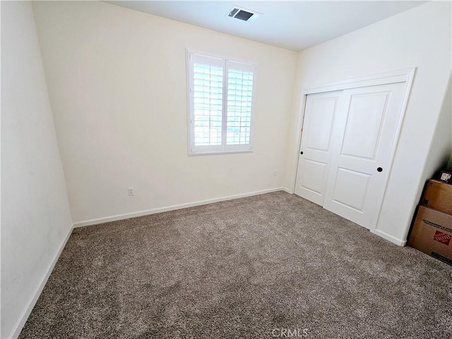 unfurnished bedroom with carpet floors and a closet