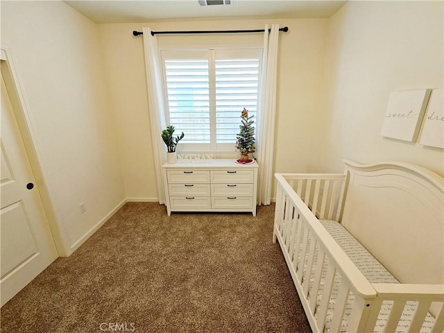 bedroom with a nursery area and dark colored carpet