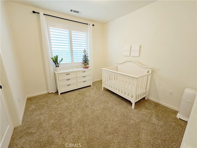 bedroom featuring a nursery area and light carpet