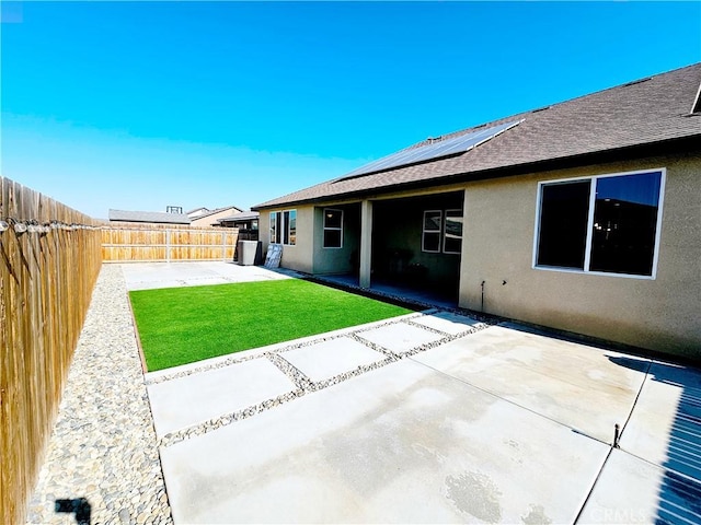 back of house with a patio and a lawn