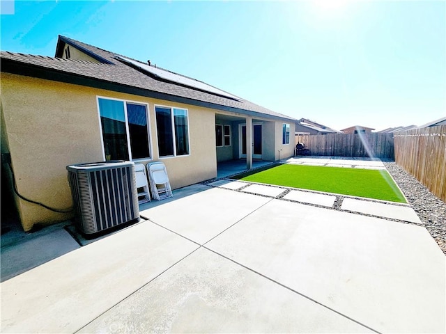 rear view of house featuring central AC unit and a patio