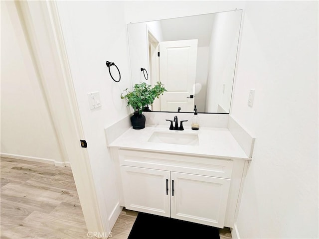 bathroom with hardwood / wood-style flooring and vanity