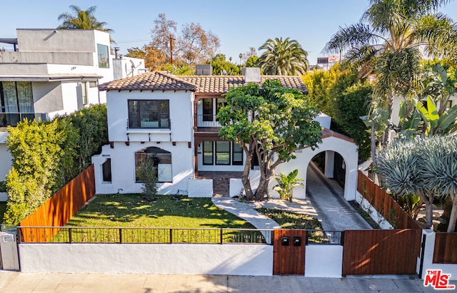 mediterranean / spanish home featuring a front yard