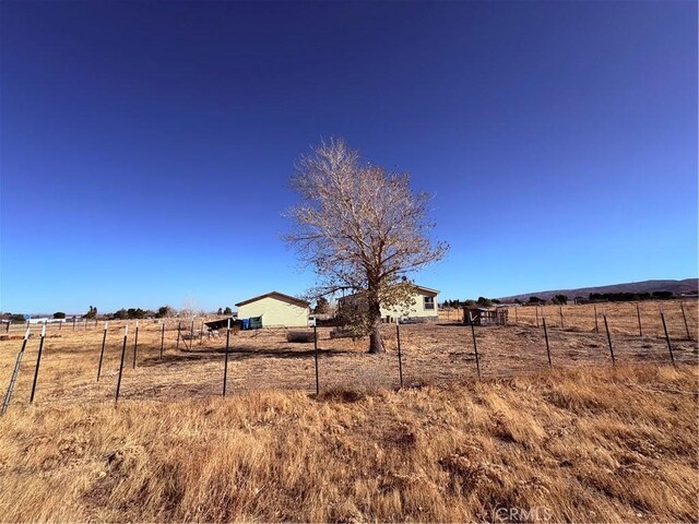 view of yard with a rural view