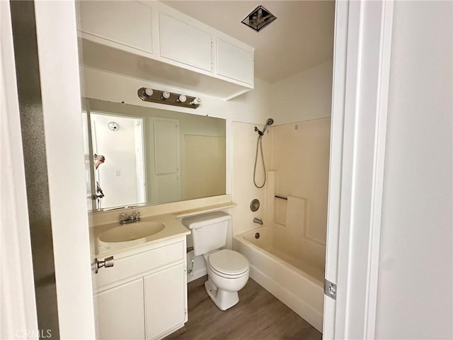 full bath with toilet, shower / bathtub combination, wood finished floors, and vanity