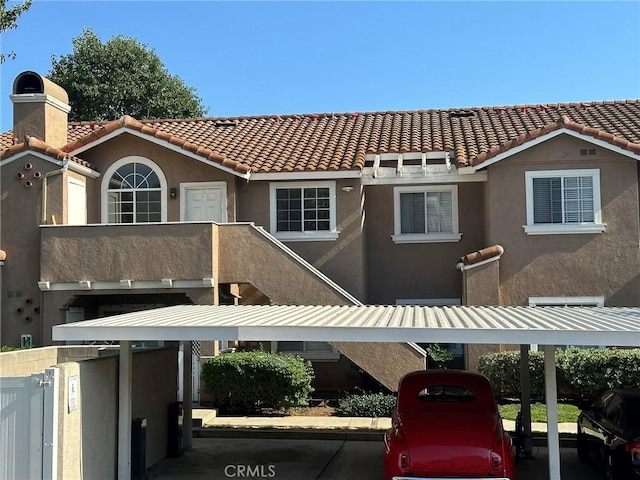 exterior space with a balcony and a carport