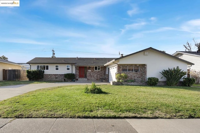 ranch-style house featuring a front yard and a garage