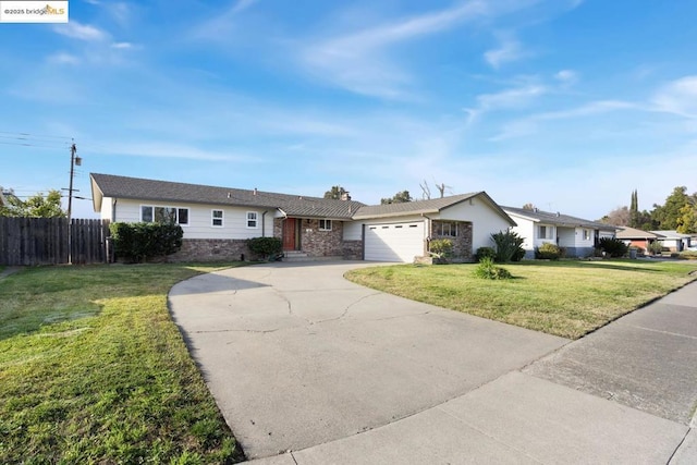 ranch-style home with a garage and a front lawn