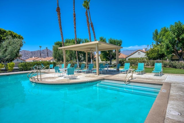 view of pool with a patio area and a mountain view