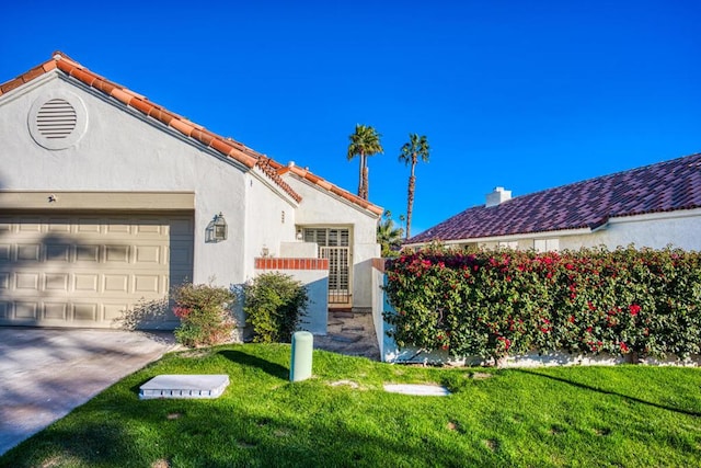 view of property exterior featuring a yard and a garage