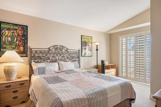 bedroom with carpet flooring and vaulted ceiling