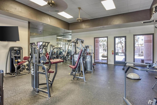 exercise room featuring a drop ceiling and ceiling fan