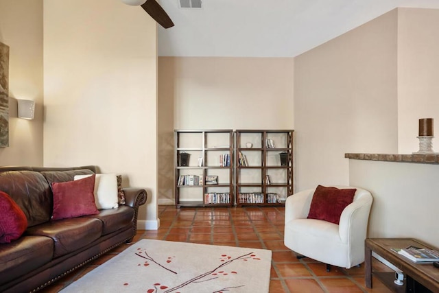 tiled living room with ceiling fan