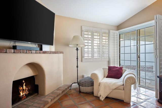 sitting room with lofted ceiling and tile patterned floors