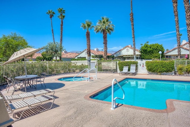 view of swimming pool with a patio