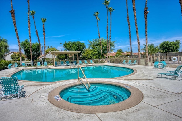 view of swimming pool with a community hot tub and a patio