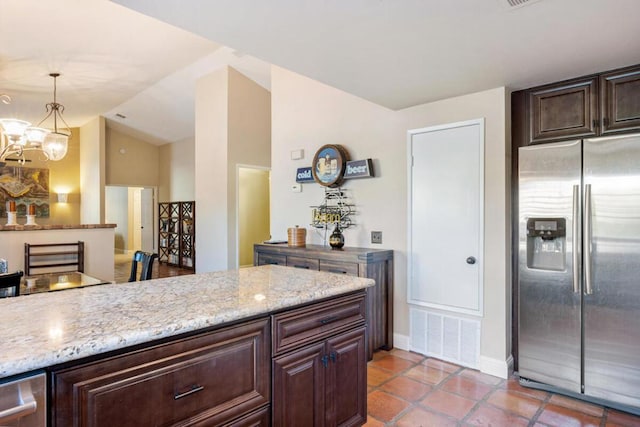 kitchen featuring light tile patterned flooring, pendant lighting, stainless steel fridge with ice dispenser, and dark brown cabinetry