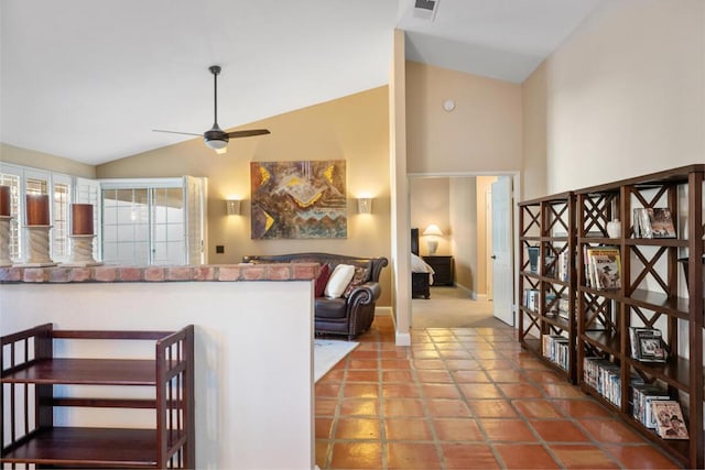 kitchen with ceiling fan, lofted ceiling, and tile patterned floors