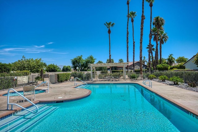 view of swimming pool with a patio area and a pergola