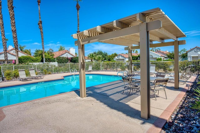 view of swimming pool featuring a patio area and a pergola