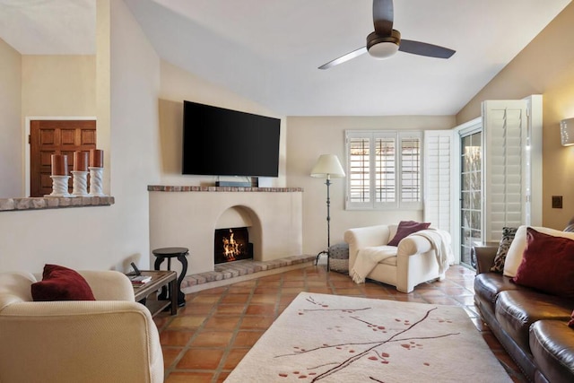 tiled living room featuring a brick fireplace and ceiling fan