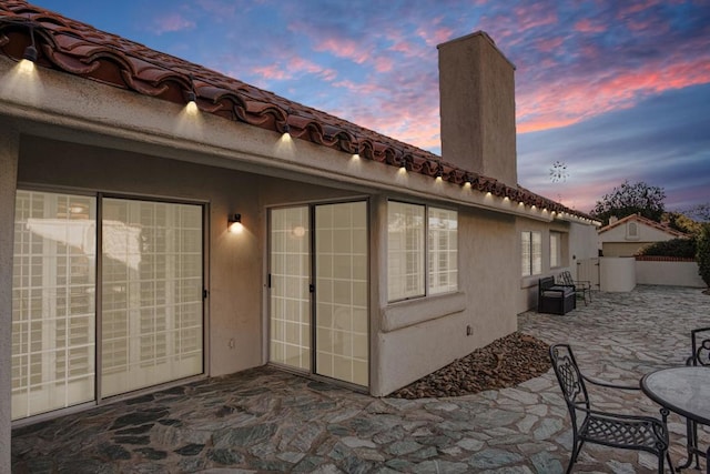 view of patio terrace at dusk