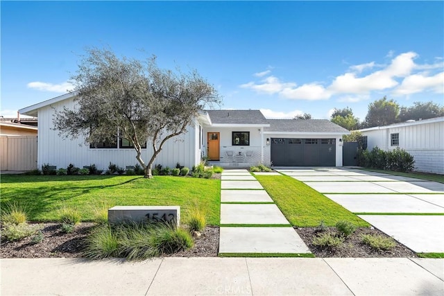 modern farmhouse style home with a front yard and a garage