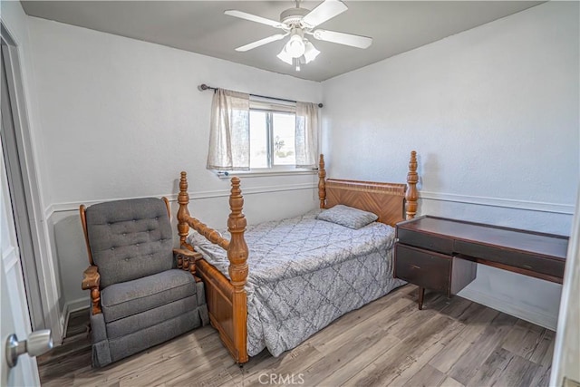 bedroom with ceiling fan and hardwood / wood-style floors