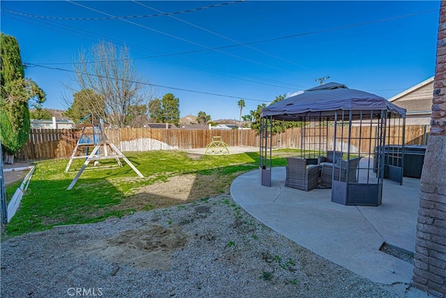 view of yard with a gazebo, an outdoor hangout area, a patio area, and a playground