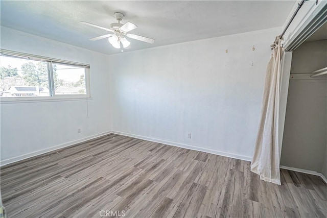 unfurnished bedroom featuring ceiling fan, light hardwood / wood-style flooring, and a closet