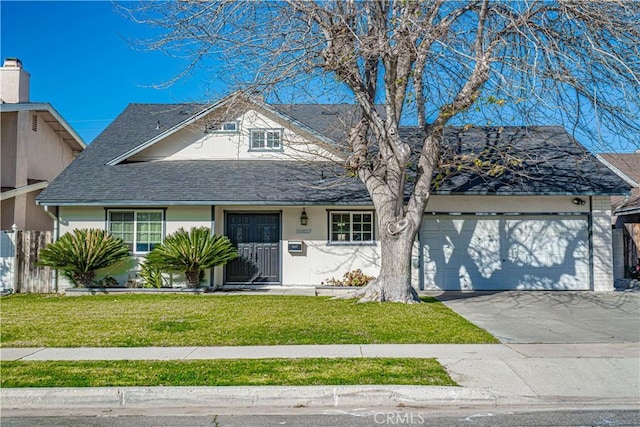 view of front of property with a front lawn and a garage