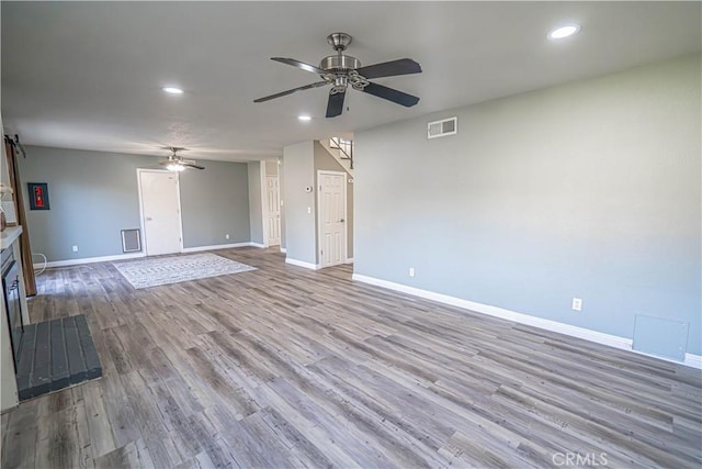 unfurnished living room with ceiling fan and light hardwood / wood-style flooring