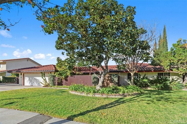 mediterranean / spanish home with a garage and a front yard