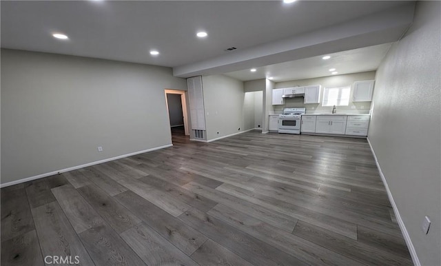 unfurnished living room featuring dark hardwood / wood-style floors and sink