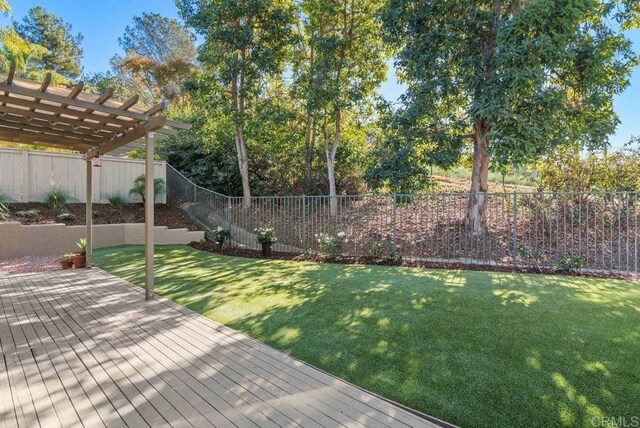 view of yard with a deck and a pergola