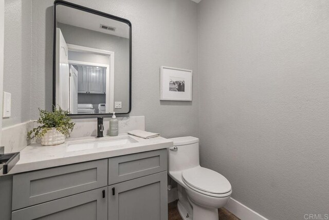 bathroom with toilet and vanity