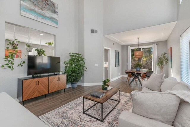 living room with dark hardwood / wood-style flooring