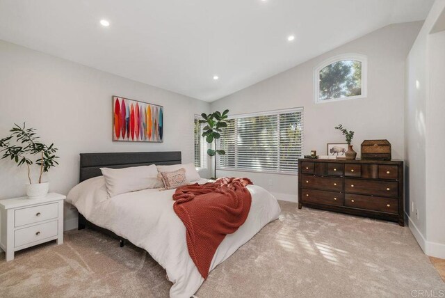 carpeted bedroom featuring lofted ceiling