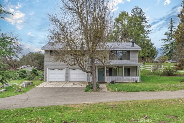 view of front of home with covered porch, a garage, and a front lawn