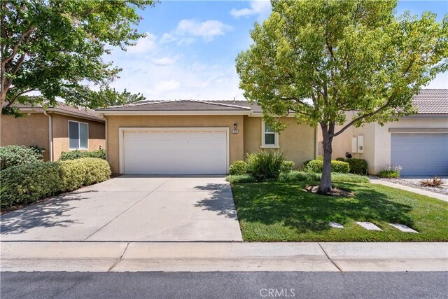 ranch-style home with a garage and a front yard