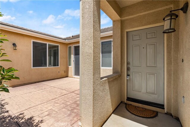 doorway to property with a patio