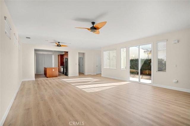 unfurnished living room with ceiling fan and light hardwood / wood-style flooring