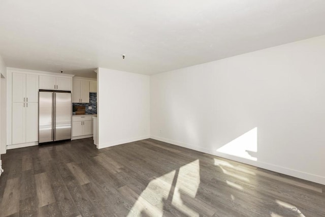 unfurnished living room with dark hardwood / wood-style floors