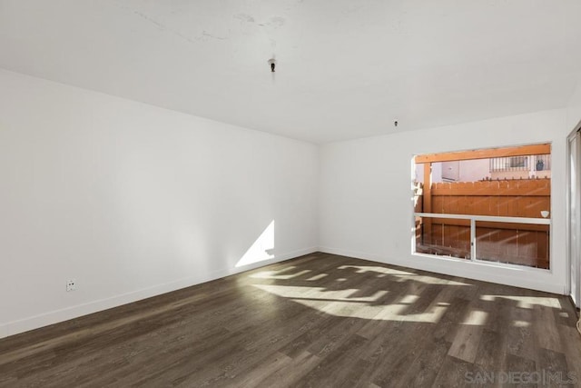 empty room featuring dark wood-type flooring