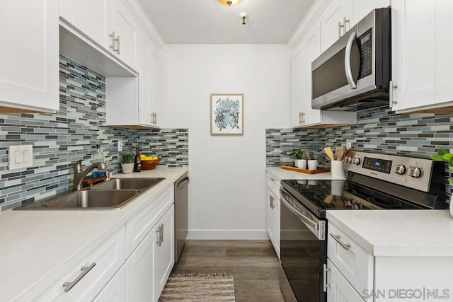 kitchen with appliances with stainless steel finishes, white cabinets, and sink