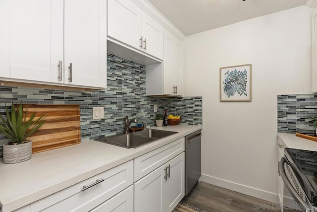 kitchen featuring appliances with stainless steel finishes, dark hardwood / wood-style floors, sink, white cabinetry, and tasteful backsplash