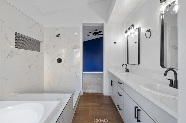 bathroom with hardwood / wood-style flooring, a washtub, vaulted ceiling, ceiling fan, and vanity