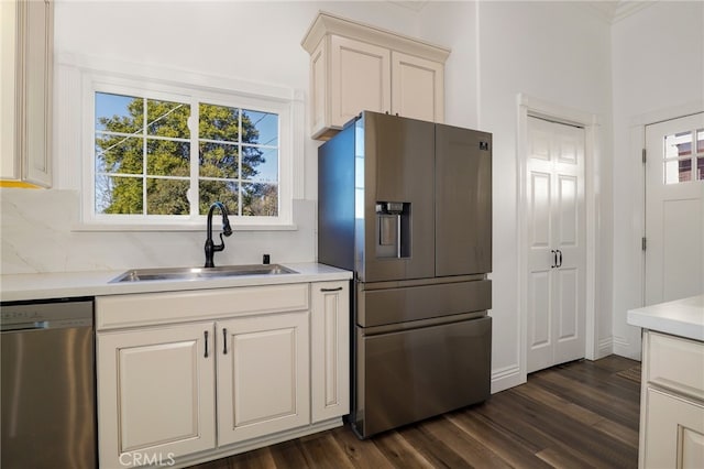 kitchen featuring sink, stainless steel appliances, dark hardwood / wood-style flooring, and tasteful backsplash