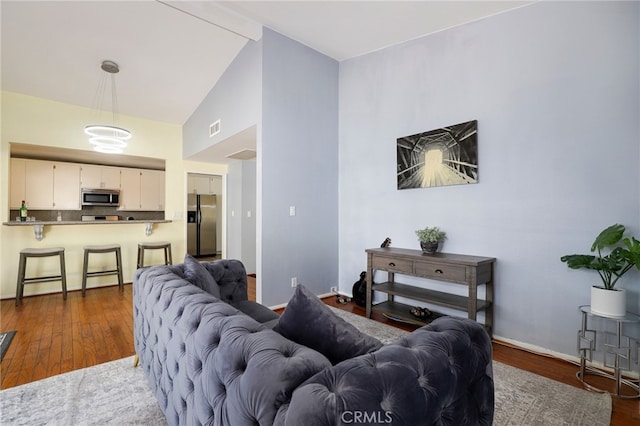 living room with lofted ceiling and dark hardwood / wood-style flooring