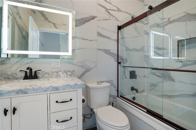 full bathroom featuring toilet, vanity, bath / shower combo with glass door, and tasteful backsplash